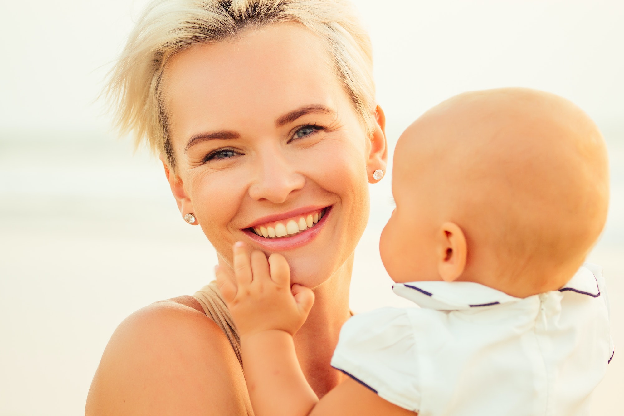 breast-feeding on breast-feeding concept. beautiful woman with baby on the summer beach at sunset